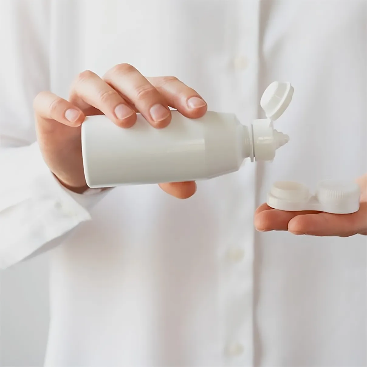 Persona utilizza del liquido disinfettante per lenti a contatto morbide